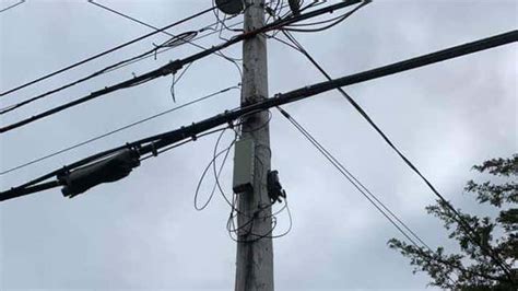 big round metal box on powerline|town's utility pole boxes.